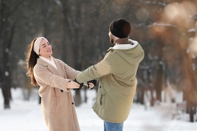 Beautiful young couple enjoying winter day outdoors