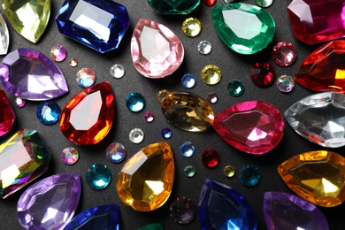 Photo of Flat lay composition with beautiful gemstones on dark background