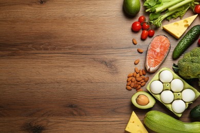 Flat lay composition with fresh organic products on wooden table, space for text. Keto diet