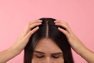 Woman with healthy hair on pink background, closeup