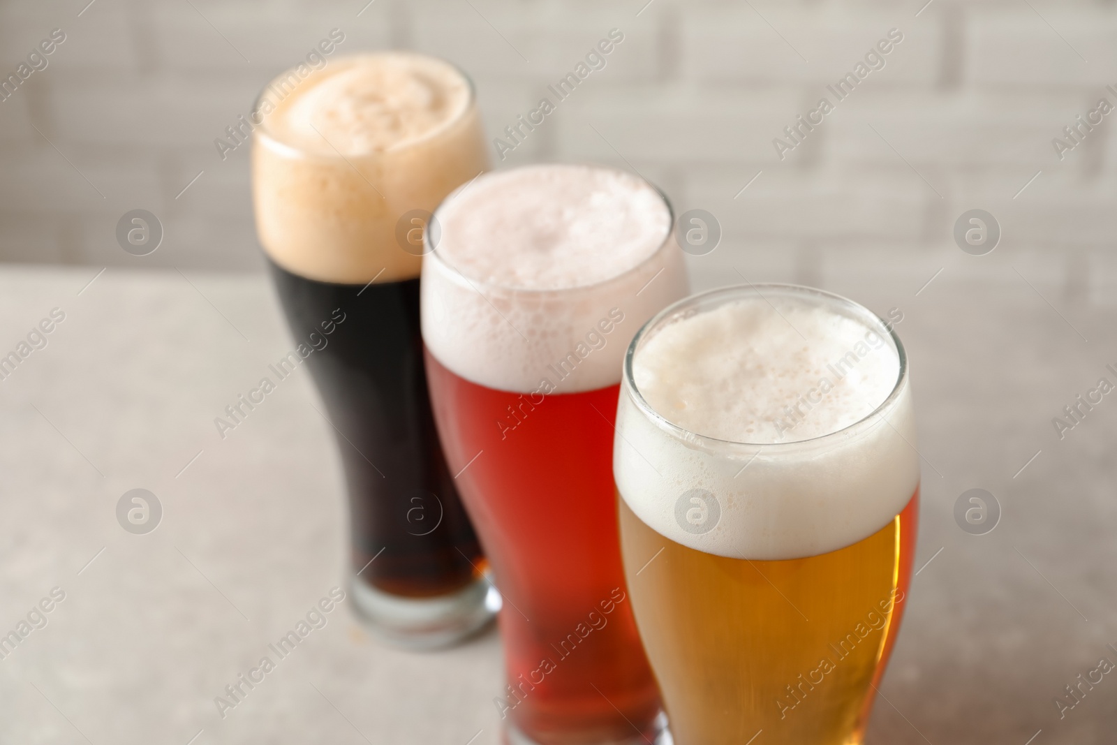 Photo of Glasses with different types of cold tasty beer on table, closeup