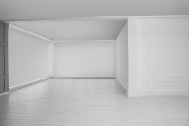 Photo of Empty room with white walls and laminated floor