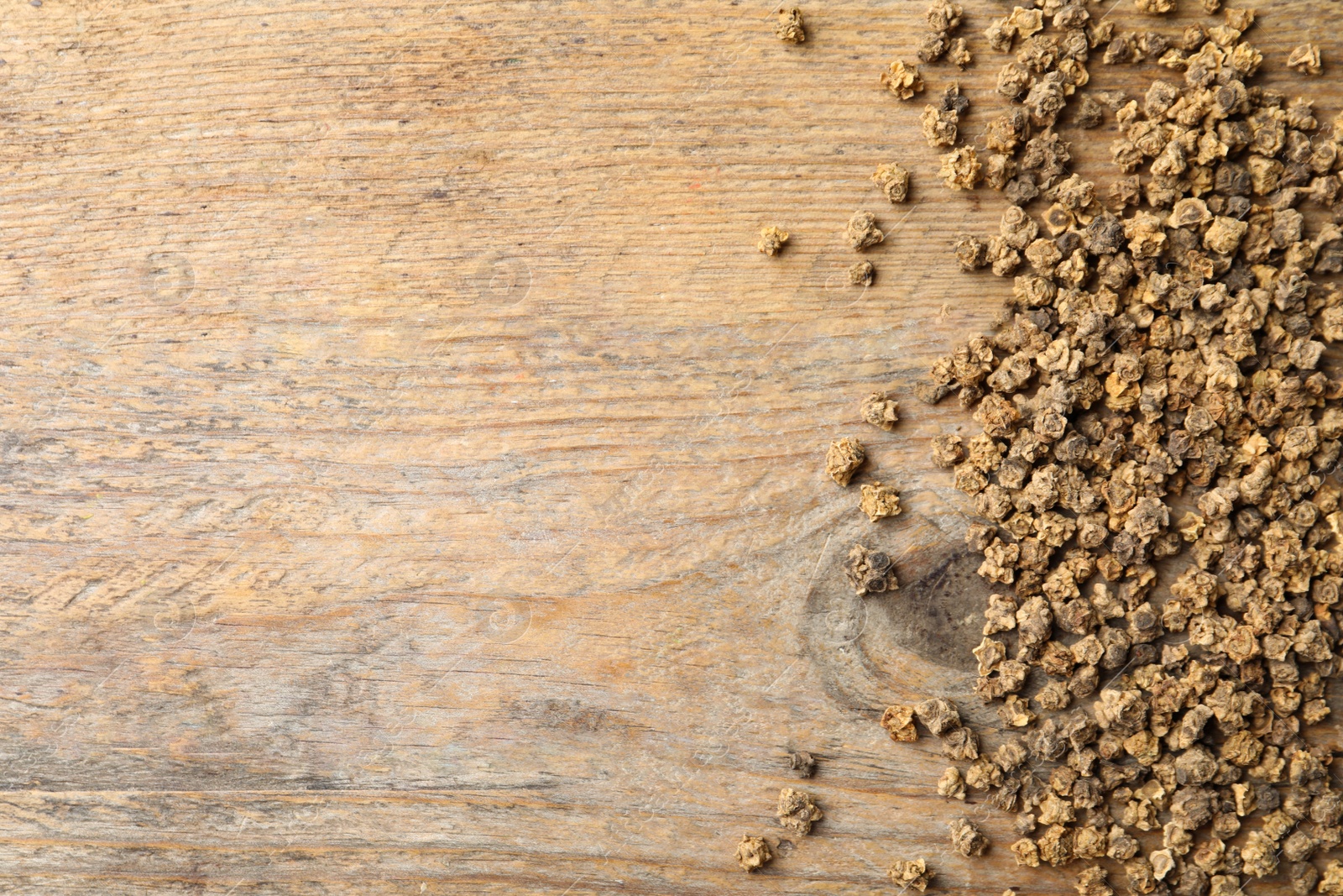 Photo of Raw beet seeds and space for text on wooden background, flat lay. Vegetable planting