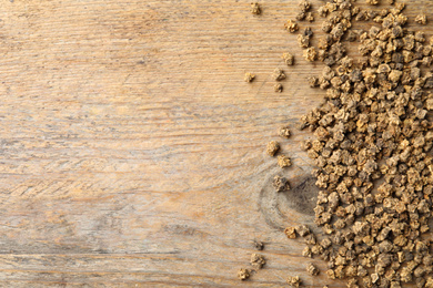 Photo of Raw beet seeds and space for text on wooden background, flat lay. Vegetable planting