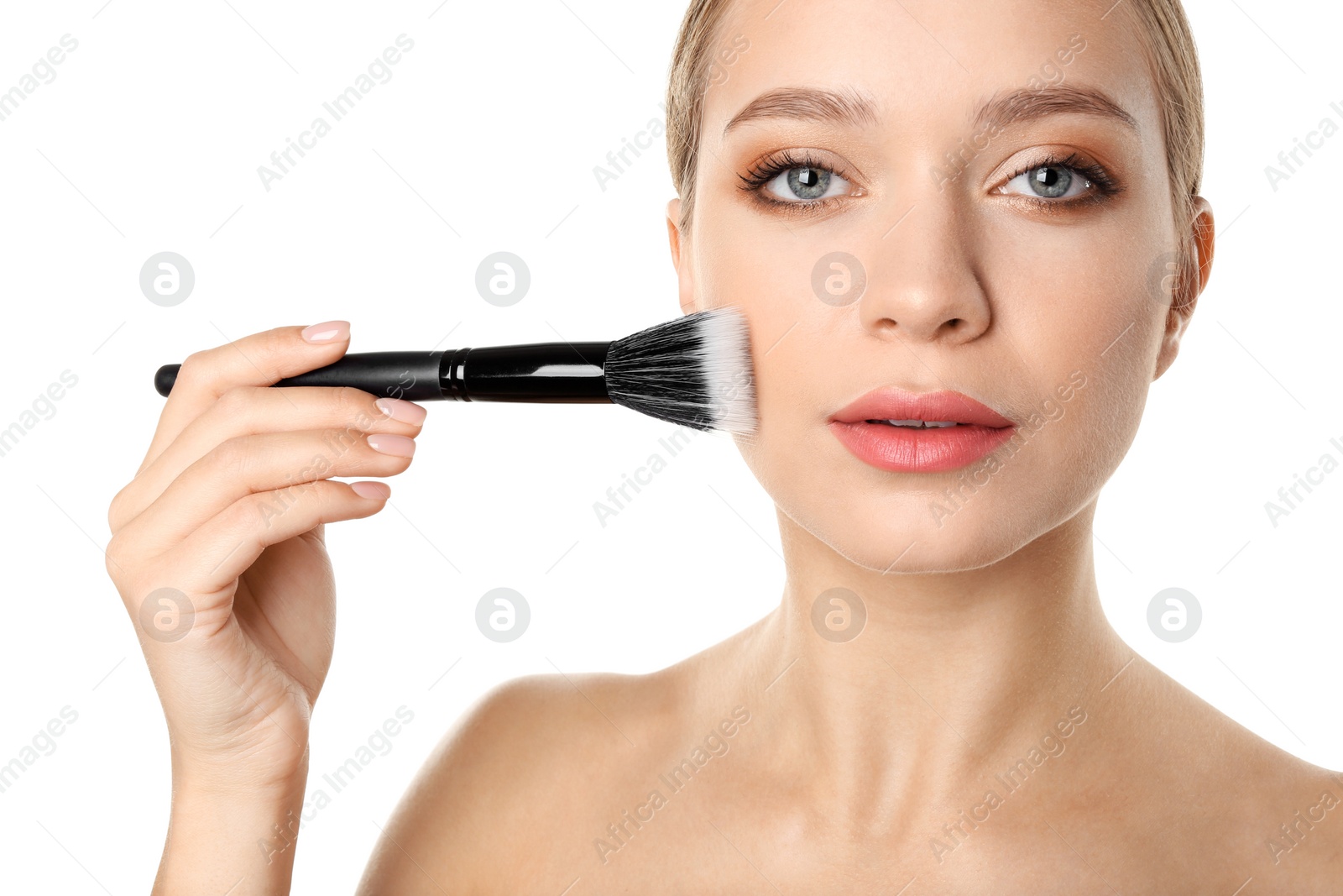 Photo of Portrait of beautiful young woman with makeup brush on white background