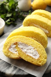 Photo of Delicious cake roll with cream filling on table, closeup