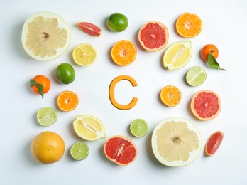 Source of Vitamin C. Different citrus fruits on white background, flat lay