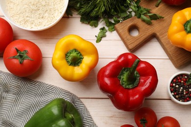 Photo of Making stuffed peppers. Rice and other ingredients on white wooden table, flat lay