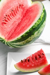 Photo of Yummy cut watermelon slices on white table