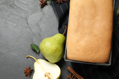 Flat lay composition with pear bread on black slate table. Homemade cake