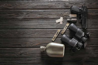 Set of military outfit on dark wooden background, flat lay