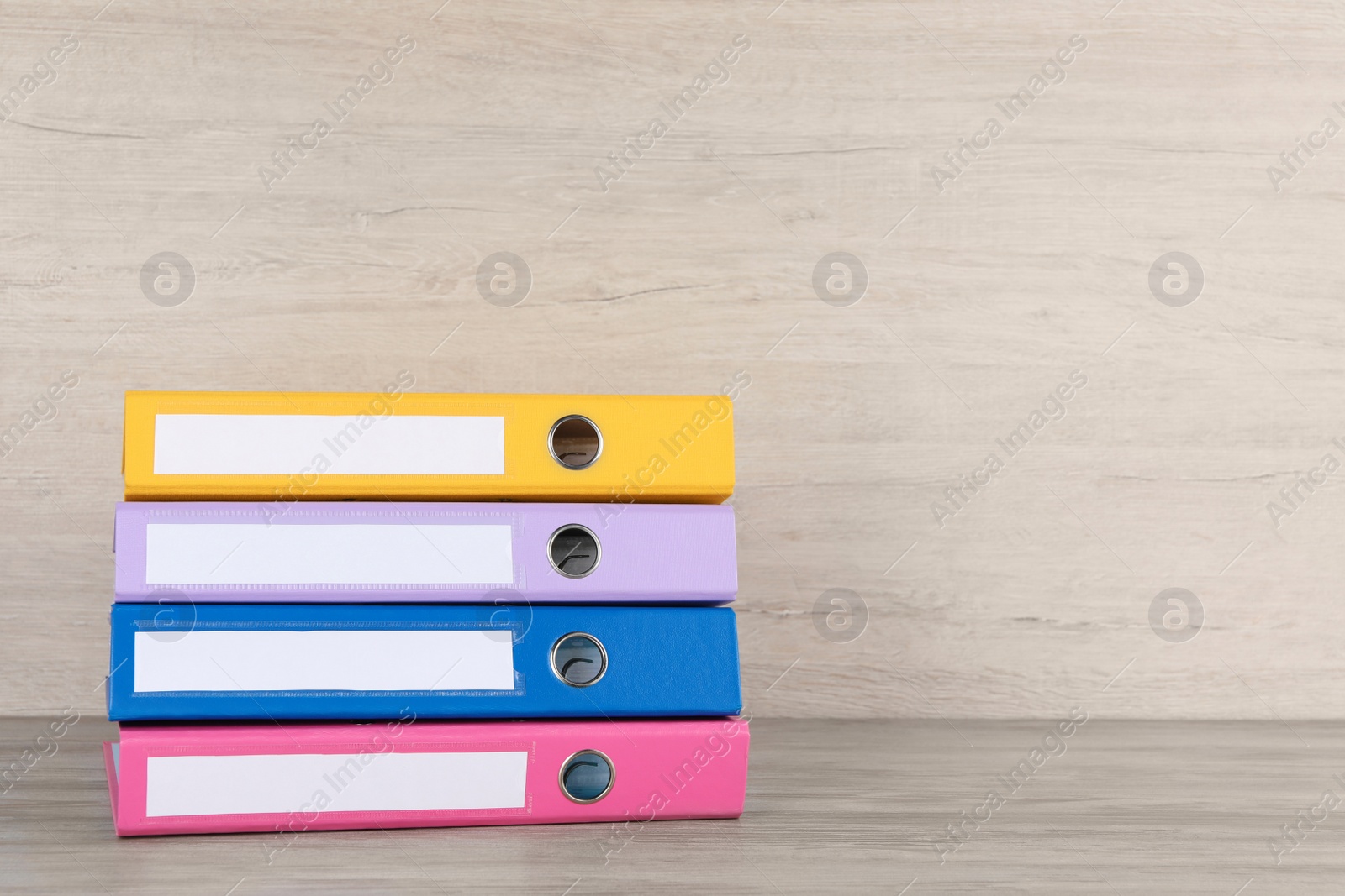 Photo of Stack of office folders on white wooden table, space for text