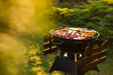 Photo of Delicious grilled vegetables on barbecue grill outdoors. Space for text
