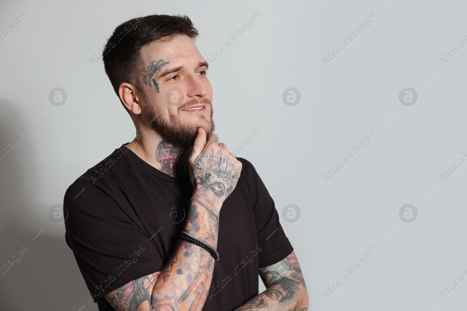 Photo of Handsome hipster man on light grey background. Space for text
