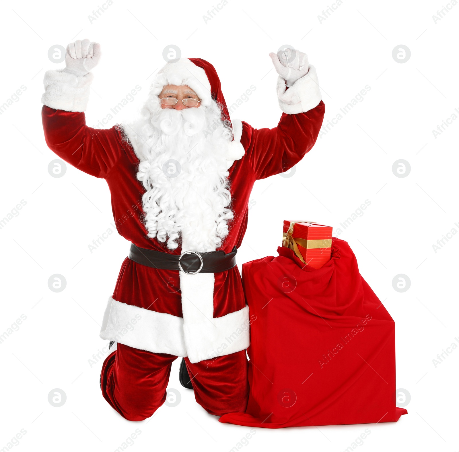 Photo of Authentic Santa Claus with bag full of gifts on white background
