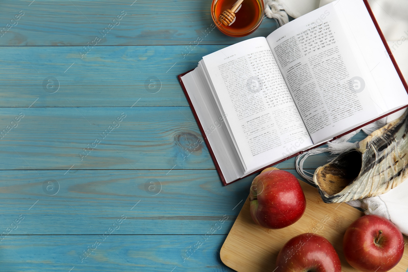 Photo of Flat lay composition with Rosh Hashanah holiday symbols on turquoise wooden table. Space for text