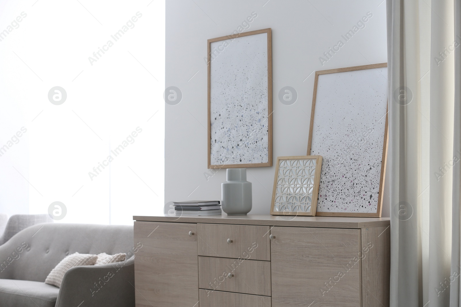 Photo of Modern room interior with stylish chest of drawers