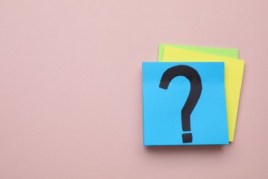 Sticky note with question mark on color background, top view. Space for text