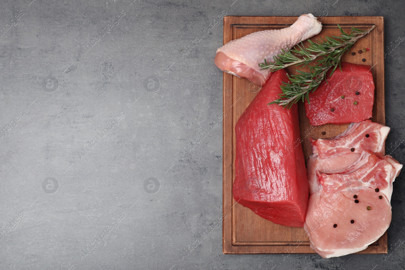 Photo of Flat lay composition with raw meat and space for text on grey background