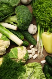 Different fresh ripe vegetables on wooden table, flat lay