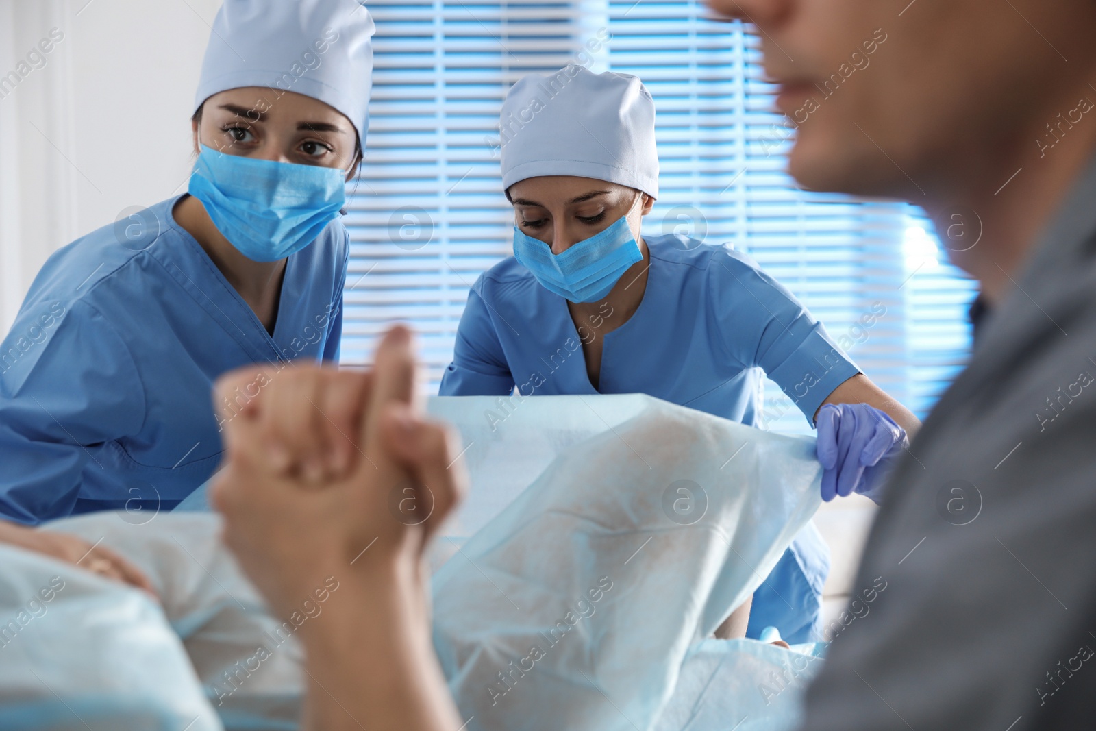 Photo of Woman giving child birth in maternity hospital, closeup