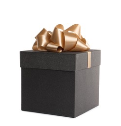 Black gift box with golden bow on white background