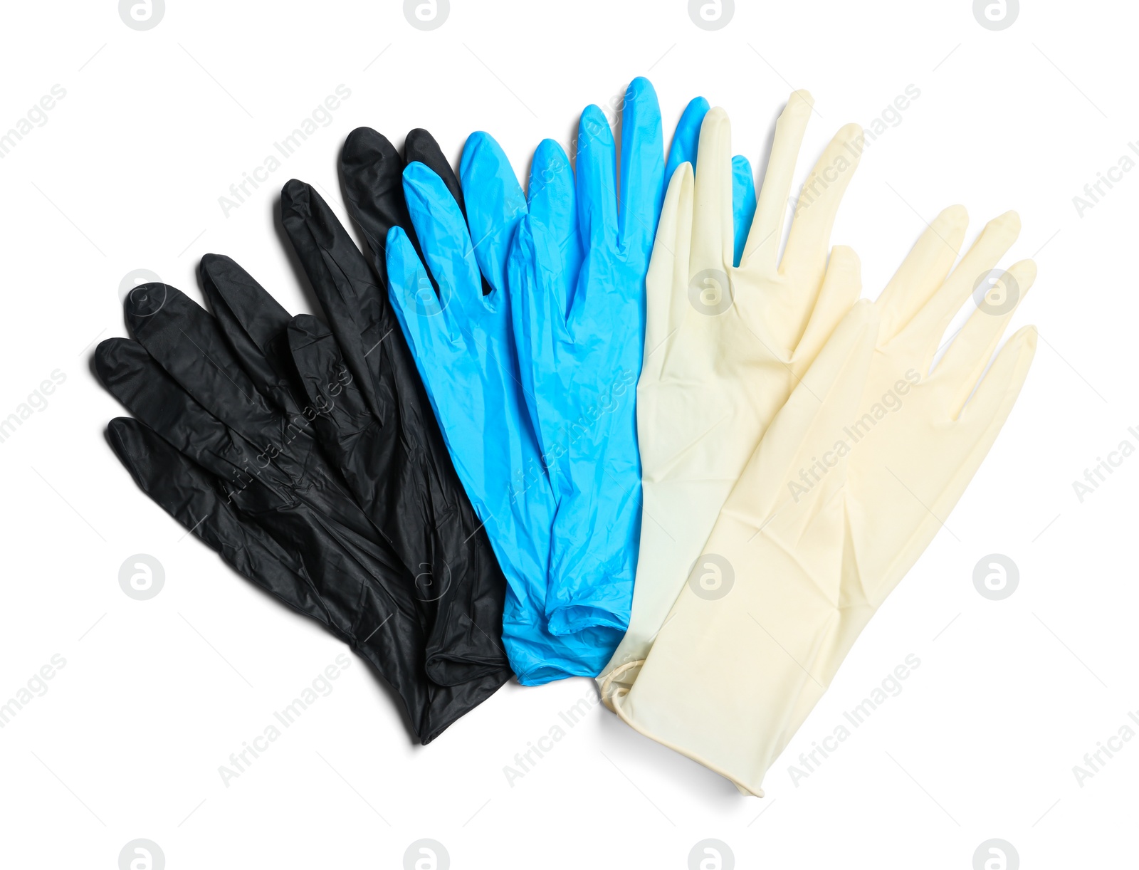 Photo of Different medical gloves on white background, top view