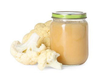 Tasty baby food in jar and fresh cauliflower isolated on white