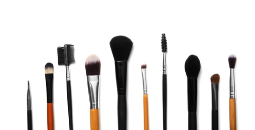 Photo of Flat lay composition with makeup brushes of professional artist on white background