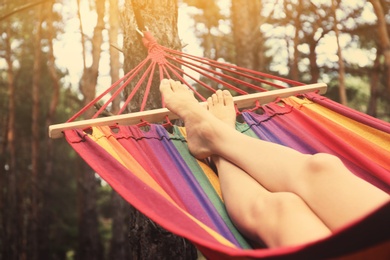 Photo of Woman resting in hammock outdoors on summer day, closeup