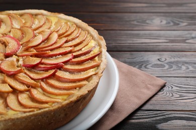 Photo of Freshly baked delicious apple pie on wooden table, closeup