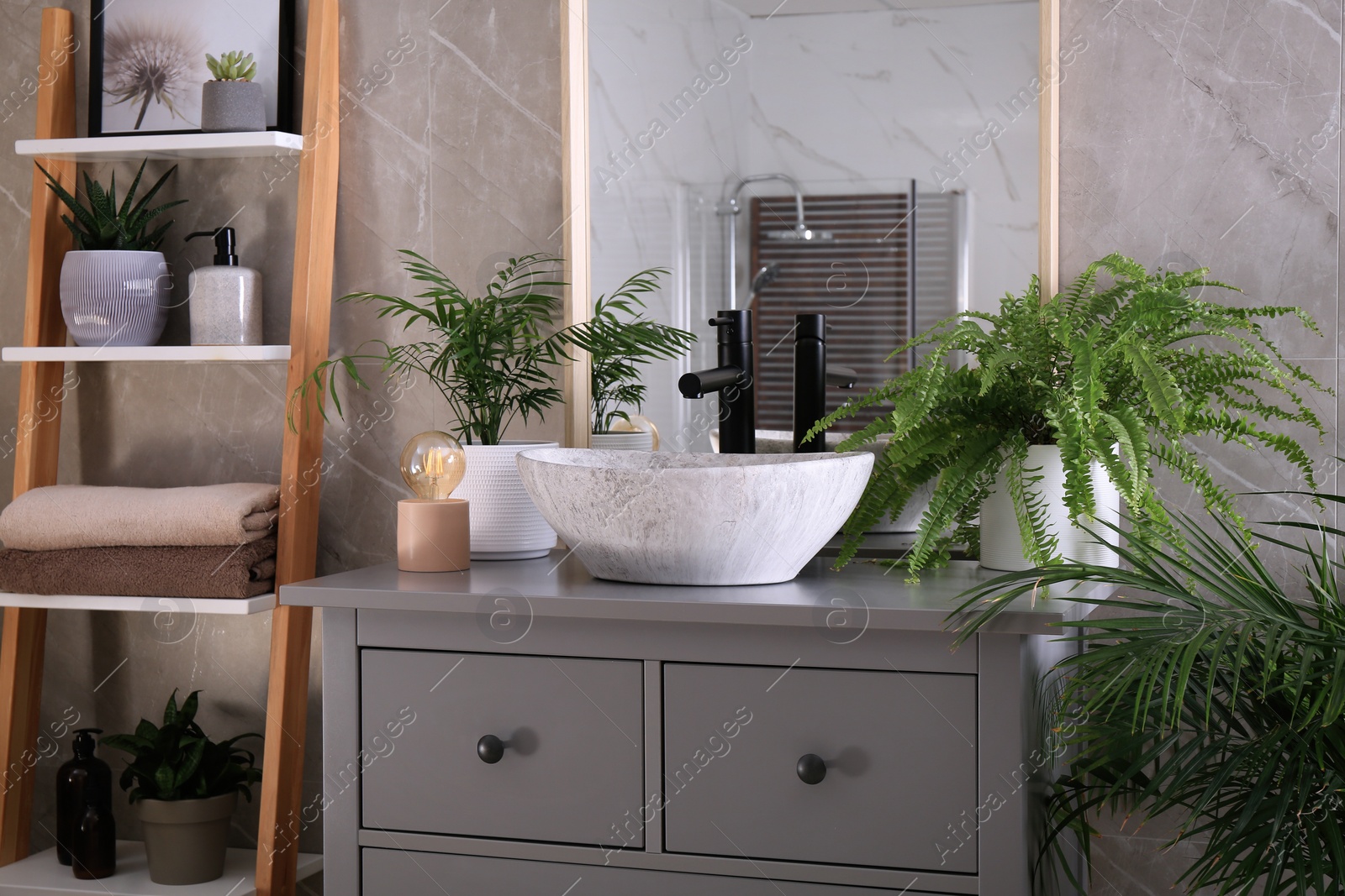 Photo of Modern bathroom interior with stylish vessel sink and beautiful green houseplants