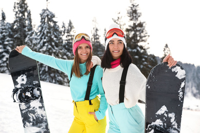Photo of Young snowboarders wearing winter sport clothes outdoors