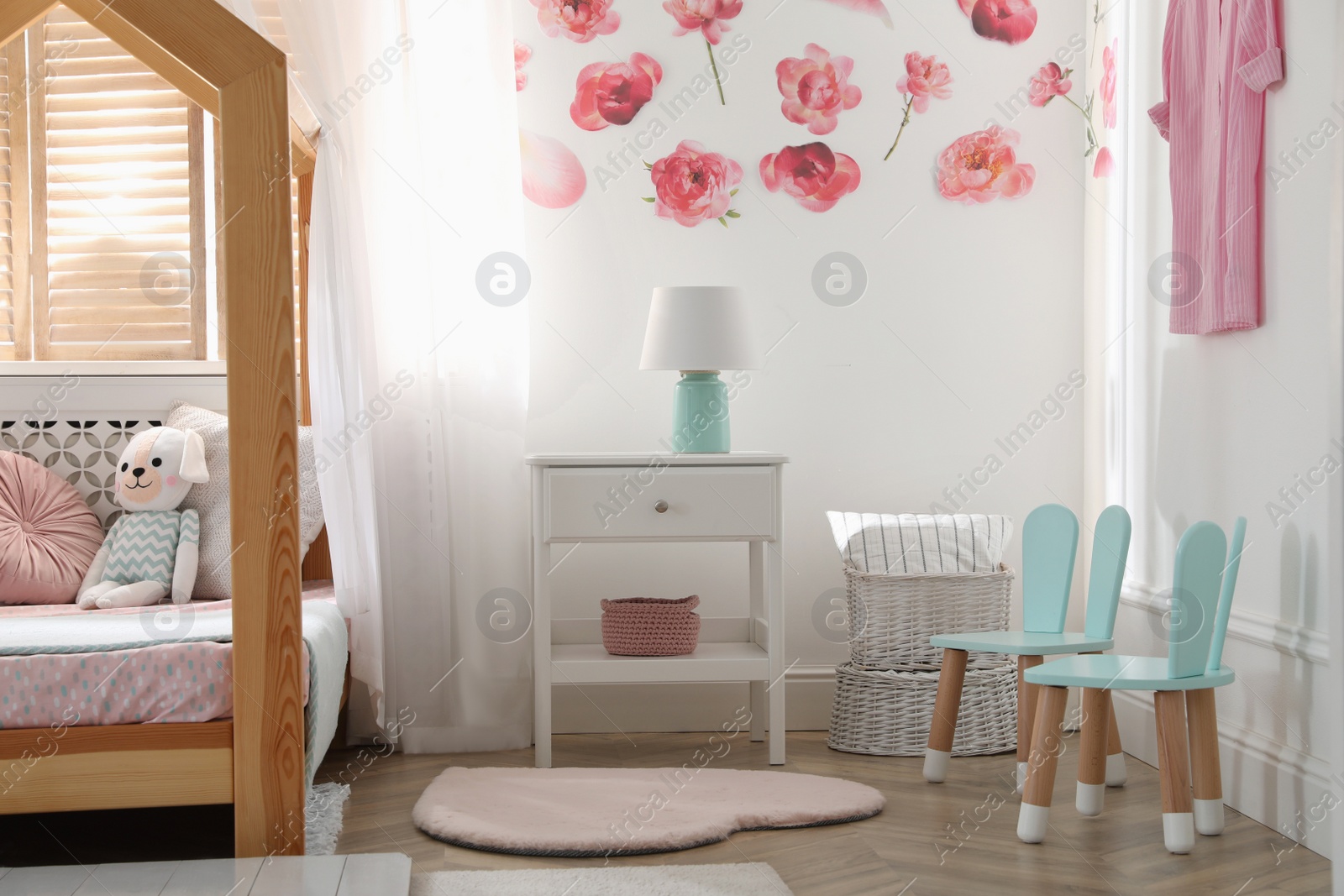 Photo of Stylish child room interior with wooden house bed