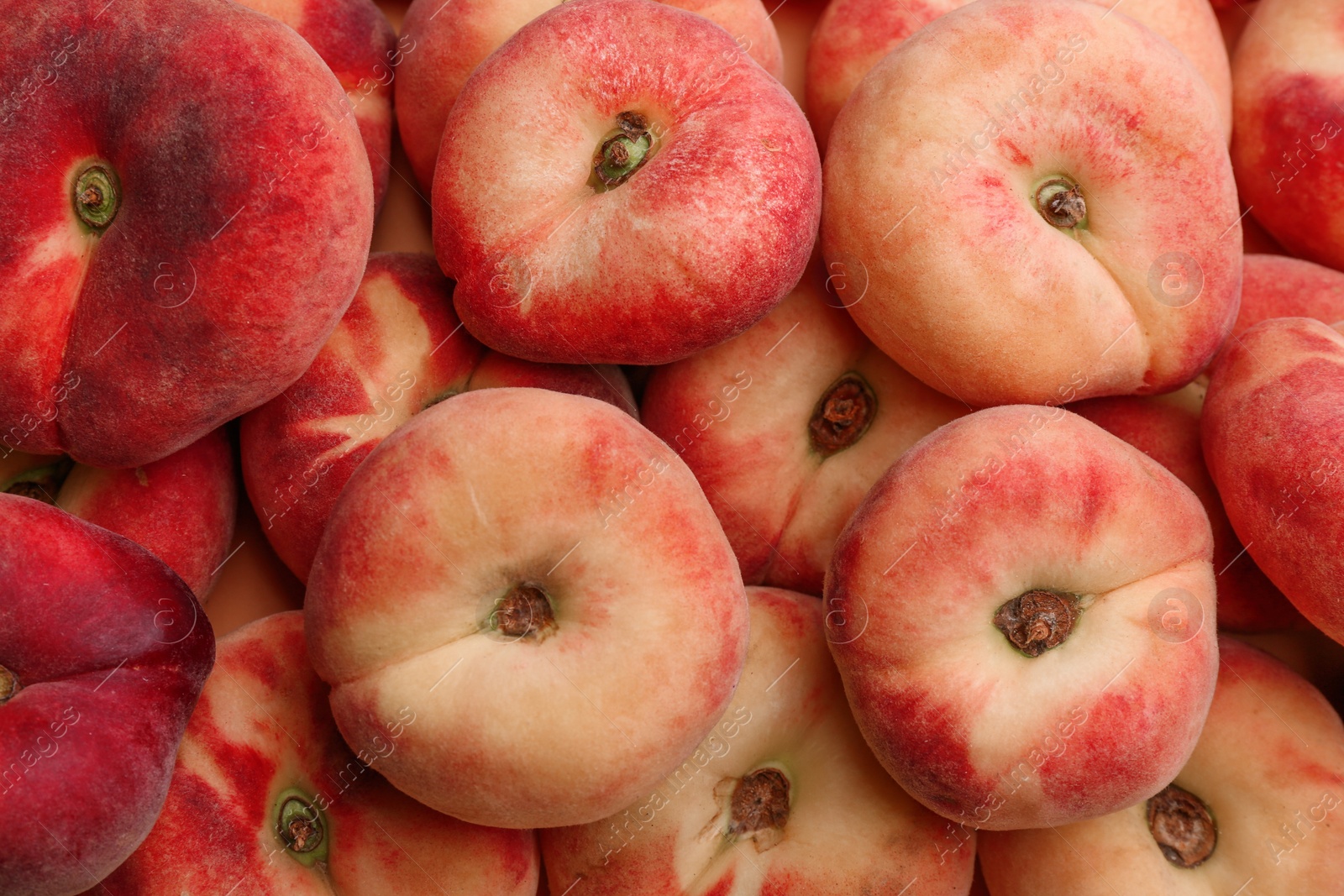 Photo of Heap of fresh donut peaches as background, closeup