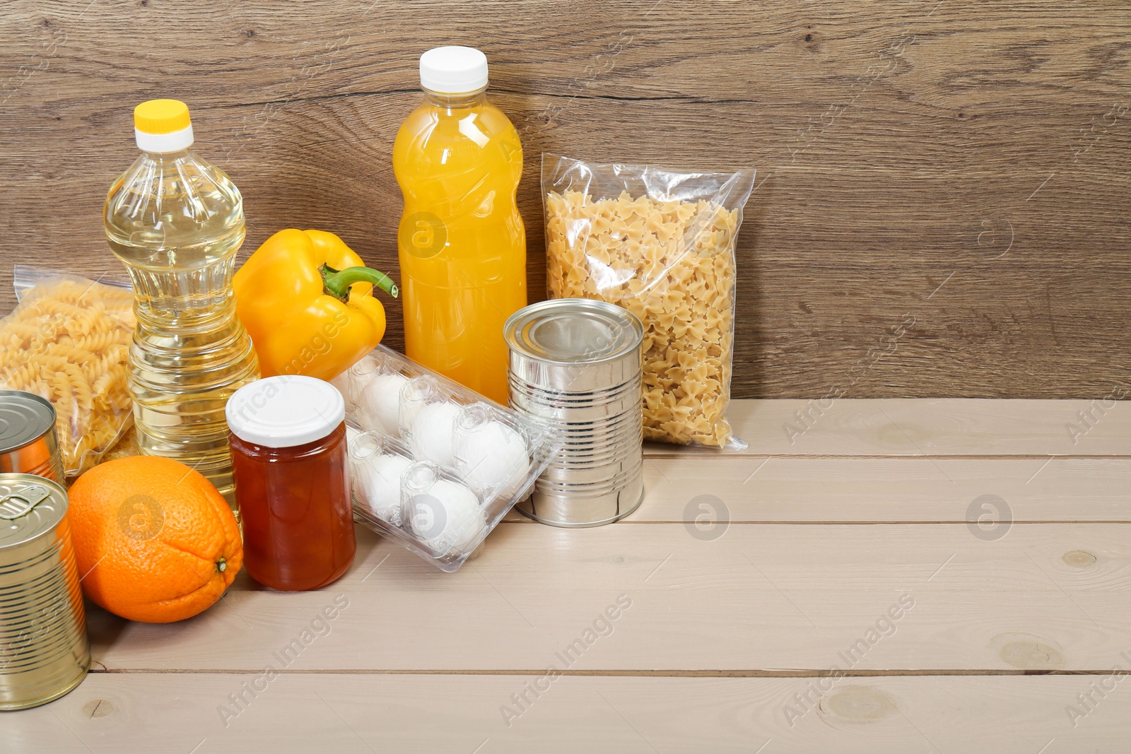 Photo of Many different donation food on wooden table, space for text