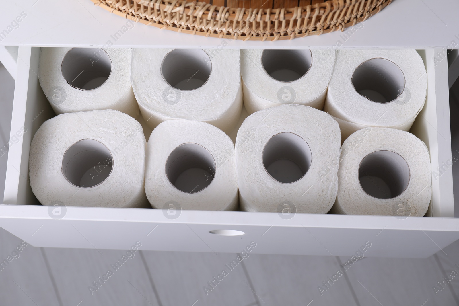 Photo of Many toilet paper rolls in white drawer indoors, top view