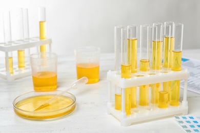 Photo of Urine samples in laboratory glassware on table. Urology concept