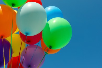 Bunch of colorful balloons against blue sky