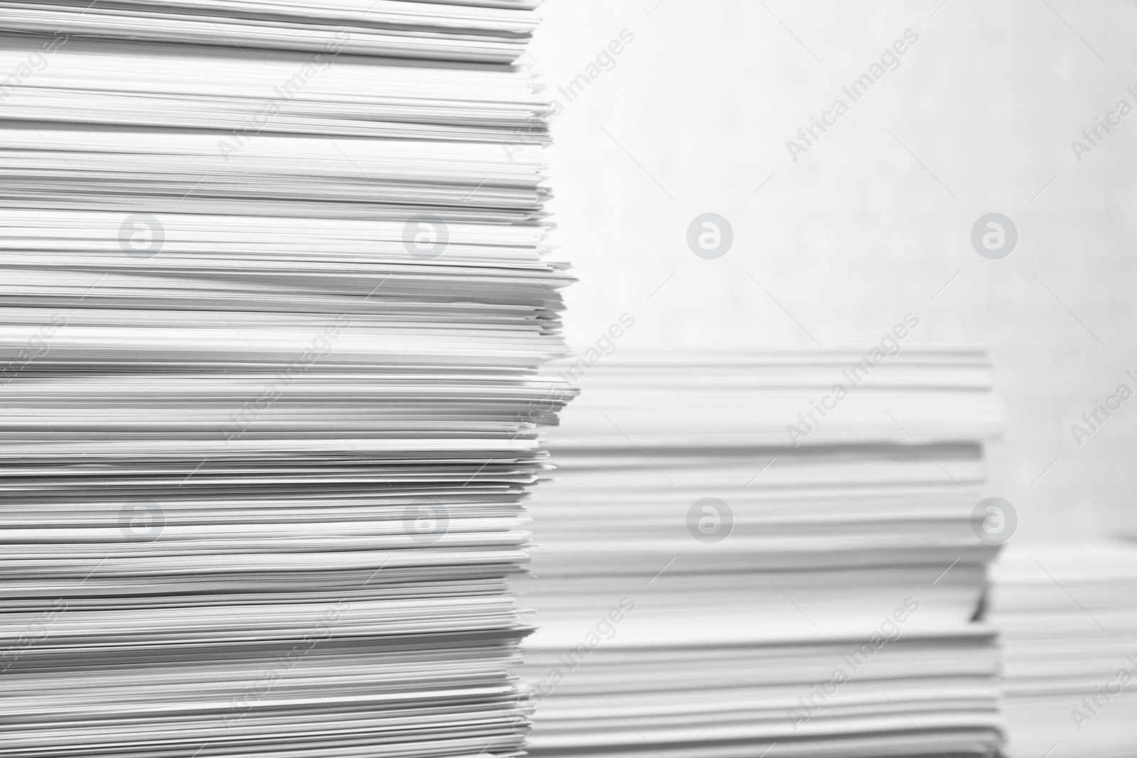 Photo of Stacks of paper sheets on white background, space for text