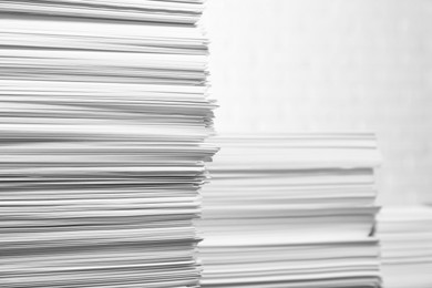 Photo of Stacks of paper sheets on white background, space for text