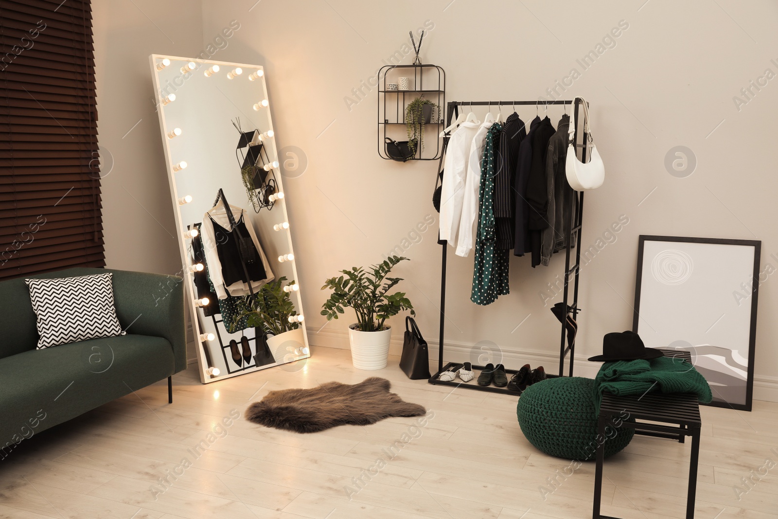 Photo of Modern dressing room interior with clothing rack and mirror