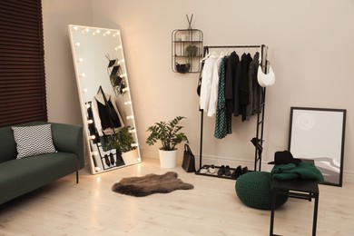 Modern dressing room interior with clothing rack and mirror