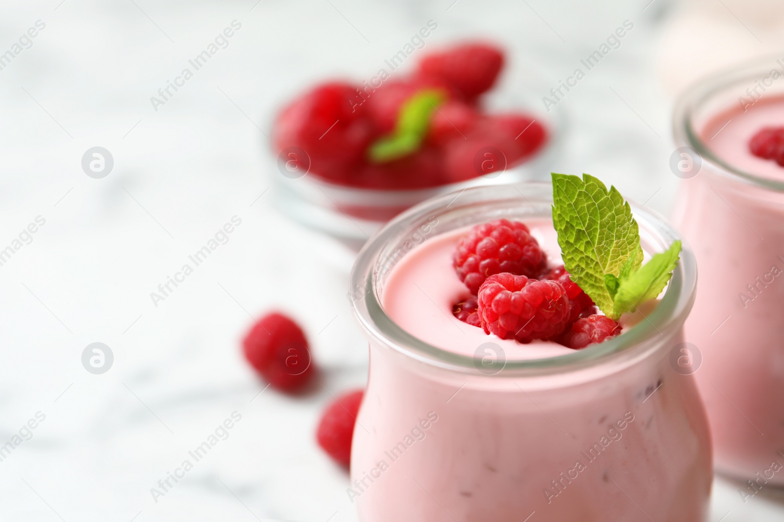 Image of Yummy raspberry smoothie in glass jar on table, closeup 