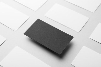 Blank black and white business cards on light background. Mockup for design