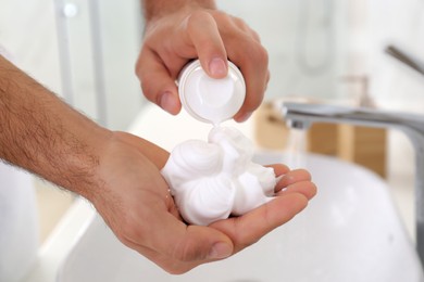 Man with shaving foam in bathroom, closeup