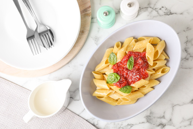 Photo of Flat lay composition with tasty pasta on white marble table