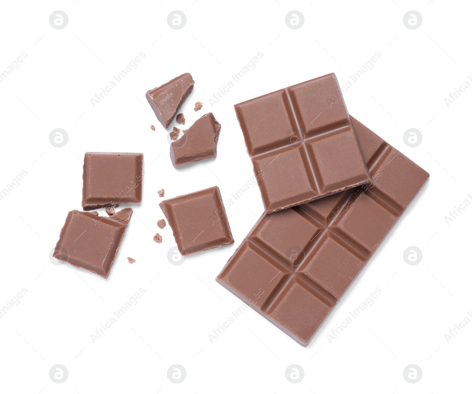 Photo of Pieces of delicious milk chocolate bar on white background, top view