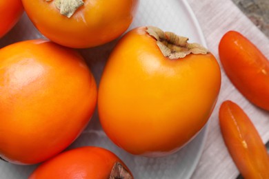 Photo of Delicious ripe persimmons on table, top view