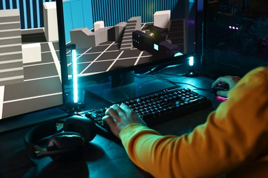 Photo of Man playing video games on computer indoors, closeup